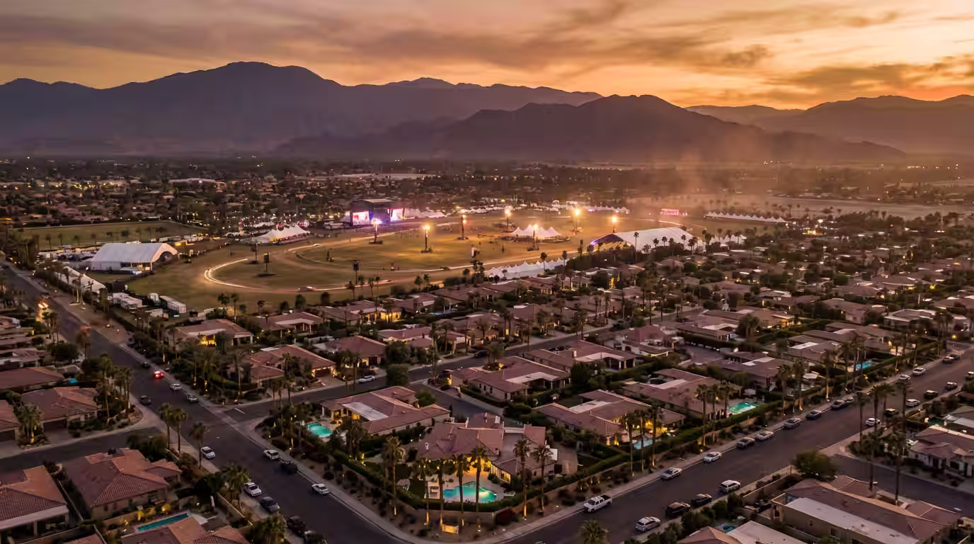Aerial view of the Coachella Valley at dusk with the festival grounds and luxury vacation rental villas
